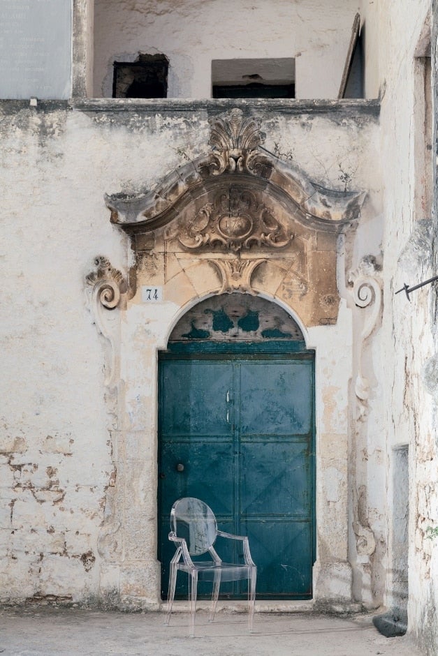 Louis Ghost Stol Crystal framför dörröppning till äldre byggnad