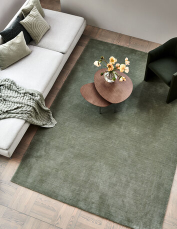 Solid Matta Grön med bruna satsbord och beige soffa